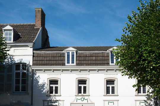 white house against blue sky in Eijsden, The Netherlands
