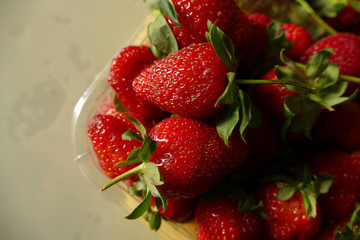 natural strawberries in a transparent container, close-up, 1 kg natural strawberry in package, close-up,