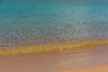 Closeup of the sand on beach and Red sea water