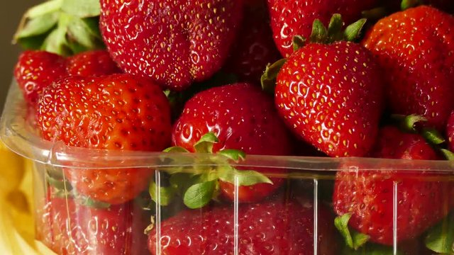 natural strawberries in a transparent container, close-up, 1 kg natural strawberry in package, close-up,