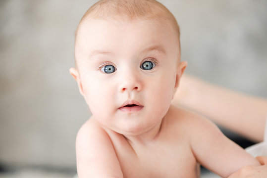 Portrait of a cute baby girl with blue eyes.