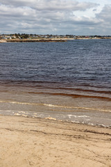 Beach with sand and buildings in Galway Bay