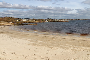 Fototapeta na wymiar Beach with sand and buildings in Galway Bay