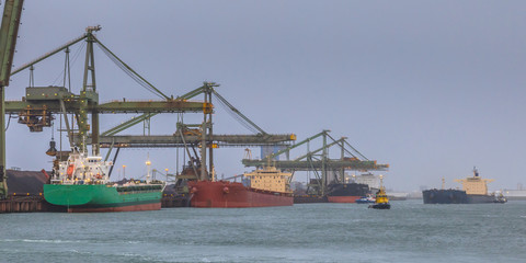 Naklejka premium Nautical bulk carrier ships in harbour