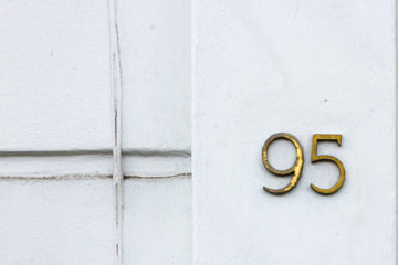 House number 95 with the ninety five on a white wall