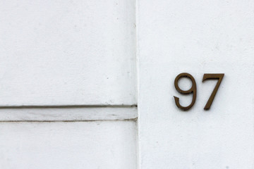 House number 97 with the ninety seven on a white wall