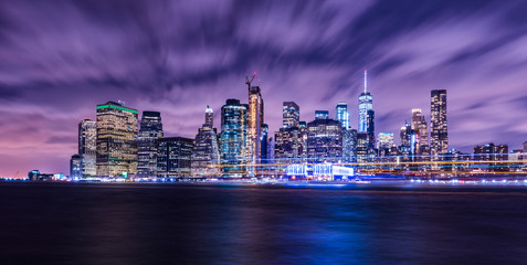 Naklejka na ściany i meble Manhattan panoramic skyline at night. Office buildings and skyscrapers. Manhattan, New York City, USA..
