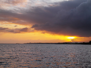 Sunset sky over Salthill, Galway city, Atlantic ocean, Galway bay. Orange sky clouds reflects in the water.