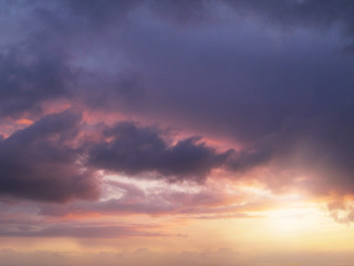 Naklejka na ściany i meble Clouds with sun, orange purple colors.