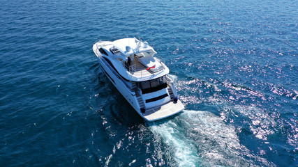 Aerial drone photo of luxury yacht cruising in mediterranean deep blue sea