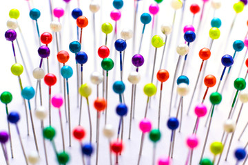 Sewing pins. Colorful sewing pins background. Close Up of sewing pins with multi colored heads....
