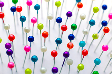 Sewing pins. Colorful sewing pins background. Close Up of sewing pins with multi colored heads. Part of set.