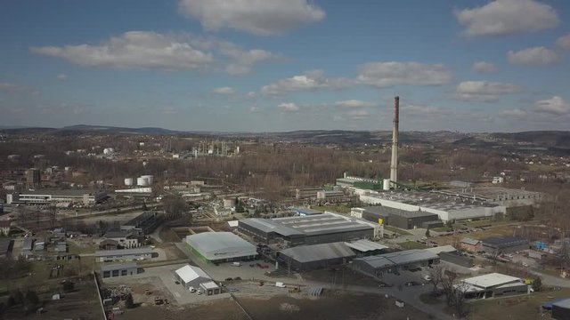 Gorlice, Poland - 3 9 2019: Industrial region of the Carpathian city. Top view of the refinery and auxiliary buildings. Video shot by drone or quadrocopter. Vanity of the day at the factory. Planning 