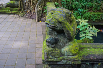 Monkey statue in Bali covered with moss