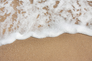 Soft sea wave on a sandy beach. beautiful background texture. empty space for your text