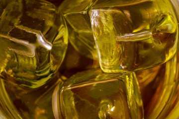 Ice cubes. Golden ice cubes close up background. Part of set.