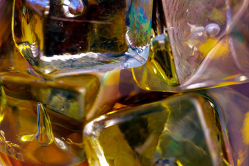 Ice cubes in liquid abstract golden background. Part of set.