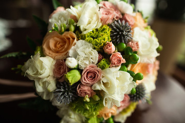 Wedding details close up. Beautiful and colourful wedding bouquet over wood table