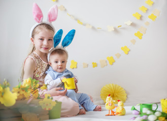 Loving cute girl and her little brother wearing bunny ears