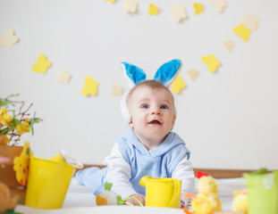 Cute baby boy with Easter bunny ears looking up