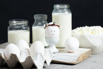 Fresh dairy and fermented milk products. Eggs On a black background.