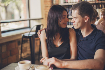 Loving couple hugging in the cafe.