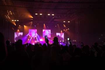Fototapeta premium many people who dance and record with the phones at the live music concert