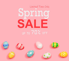 Spring sale message with Easter eggs on a pink background