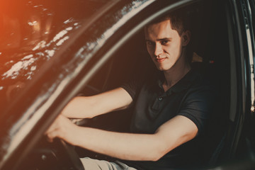 Fototapeta na wymiar Young man sitting in his car.