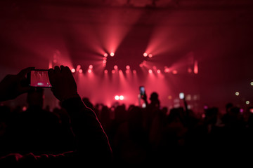 many people who dance and record with the phones at the live music concert