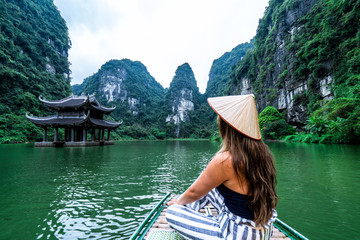 A woman on a river boat in Ninh Binh.  Mountains of northern Vietnam.