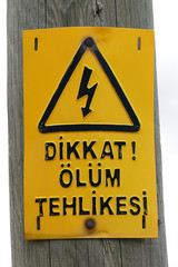 Turkish "attention danger of death" warning sign, hanging on mast,