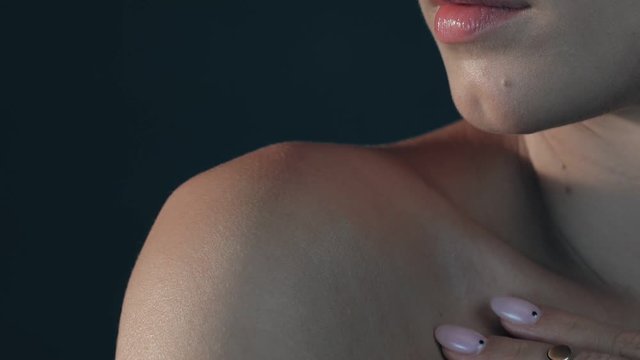 young beautiful woman with jewelry on her neck turns to the camera