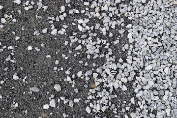 pitch and pebbles on asphalt road, close-up,