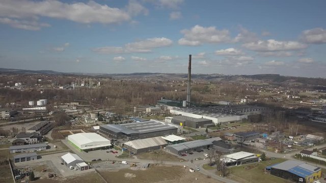 Gorlice, Poland - 3 9 2019: Industrial region of the Carpathian city. Top view of the refinery and auxiliary buildings. Video shot by drone or quadrocopter. Vanity of the day at the factory. Planning 