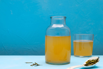 Fermented kombucha tea on blue background. Image with copy space.
