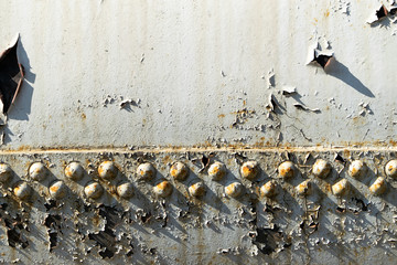 A lot of rivets on the wagon of an old train texture in summer