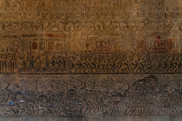Wall carvings of Angkor Wat, Siem Reap background