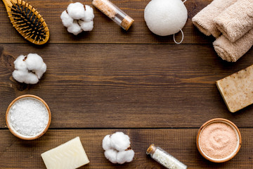 Organic cosmetics and eco materials for homemade spa on wooden background top view mock up