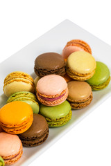 Colorful Macaroons Chocolate, Pistachio, Cherry, Orange, Vanilla Flavor Background Isolated on White Background. Selective focus.