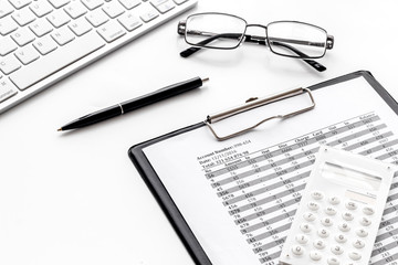 business accounter work with taxes calculation and keyboard on white office desk background