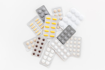 Pills and drugs on white background top view