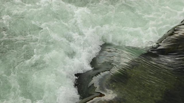 Splashing water current over a dam
