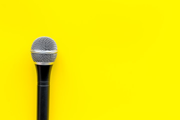 blogger, journalist or musician work space with microphone on yellow background top view space for...