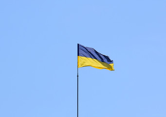 Ukraine national flag waving on wind. Sky background.