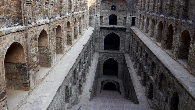 a panning right shot of agrasen ki baoli step well in delhi, india
