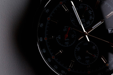 Fototapeta premium Close up front view of a modern wrist watch on the table. Soft focus. 
