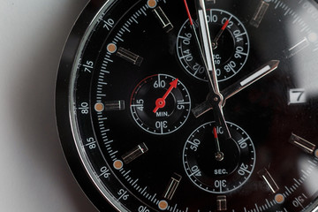 Close up front view of a modern wrist watch on the table. Soft focus. 