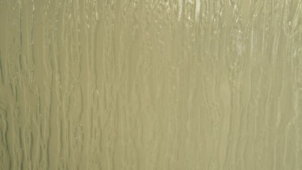 Close-up photo of a textured glass with semi-transparent properties.