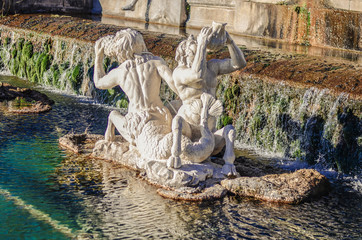 Fototapeta na wymiar a beautiful fountain with statues and rocks in Caserta, Italy